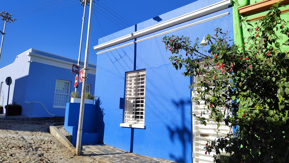 a blue building with a green door and window