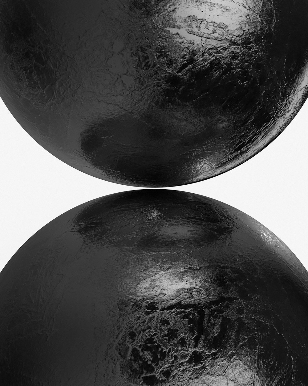 a pair of black balls sitting on top of each other