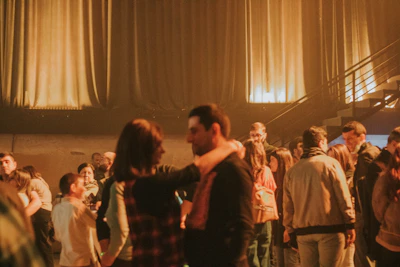 Guests laughing and dancing under soft amber lighting in the lounge area.