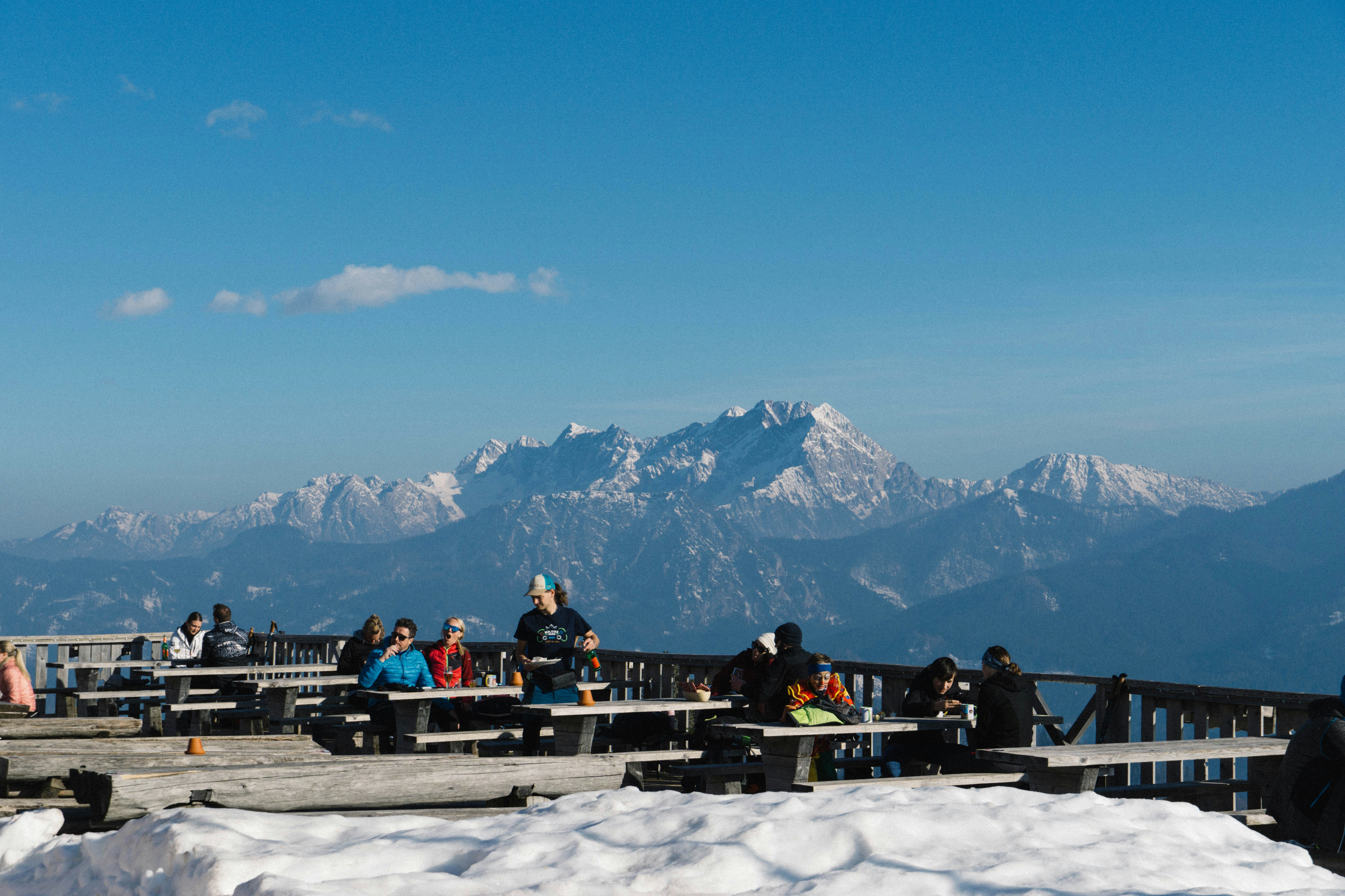 a group of people standing on top of a snow covered slope
