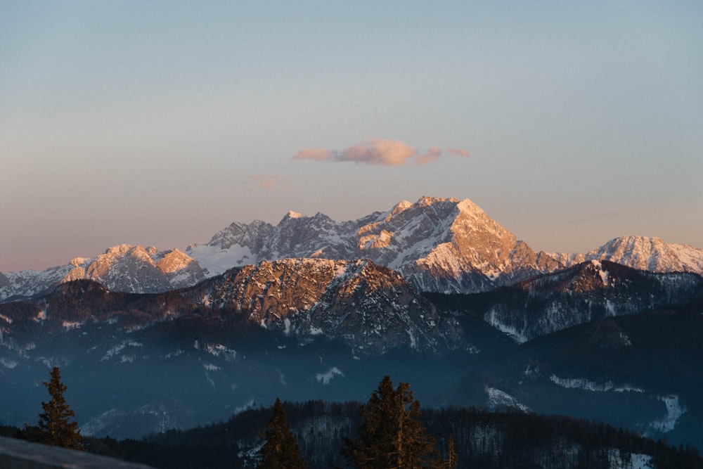 a mountain range with snow covered mountains in the background