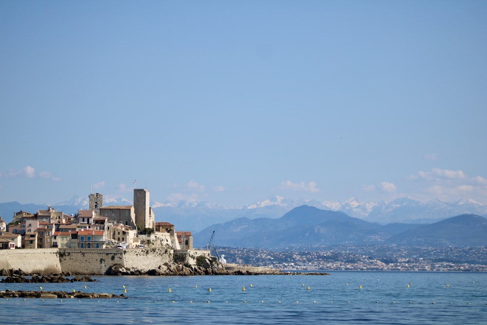 a view of a city from the water with mountains in the background