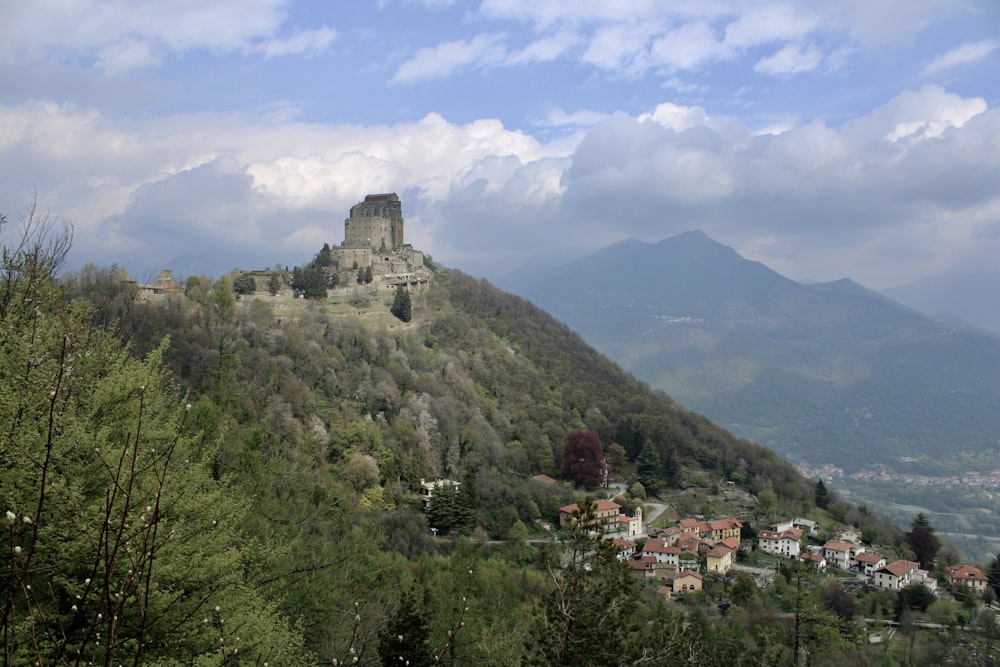 a castle on top of a hill surrounded by trees