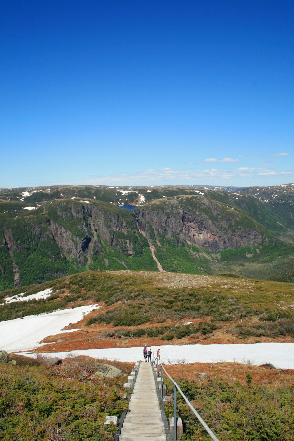 a wooden walkway leading up to a mountain