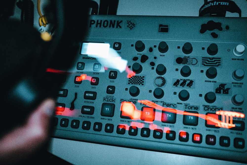 a close up of a sound board with a person holding a magnifying glass