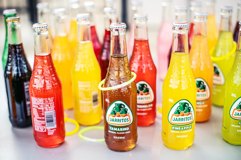 a group of bottles of soda sitting on top of a table