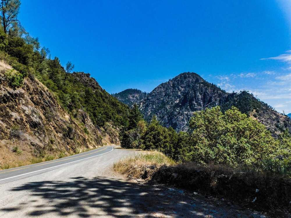 a view of a mountain road from the side of the road