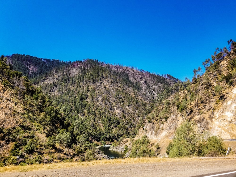 a scenic view of a mountain with a road in the foreground