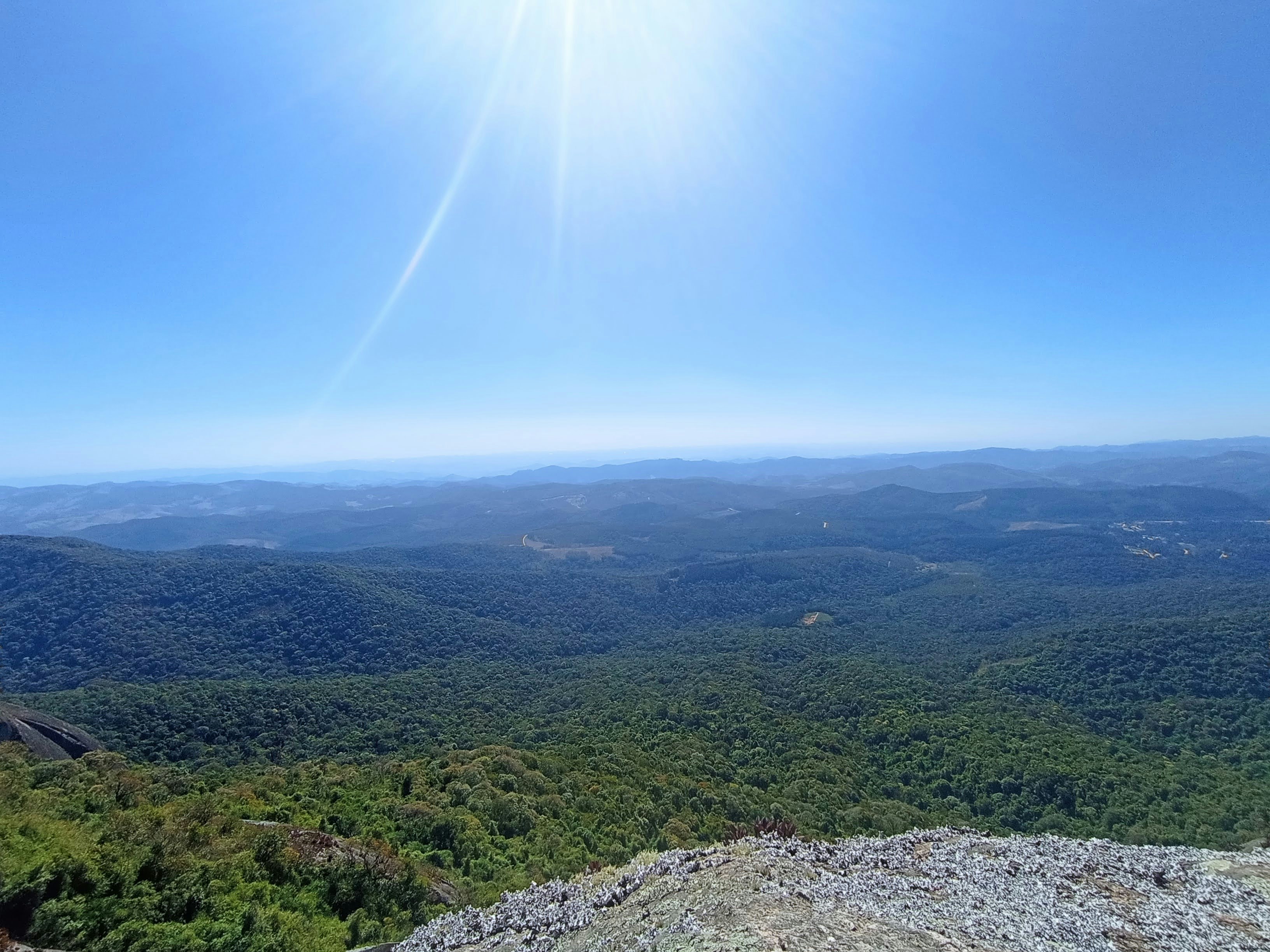 the sun is shining over a mountain range
