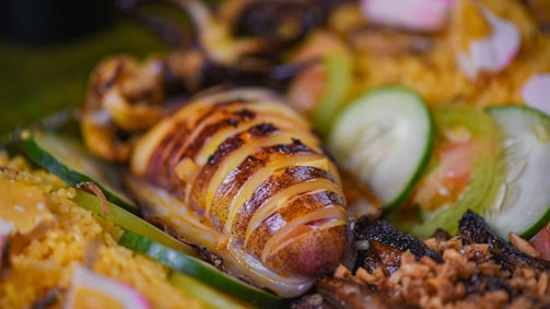 a close up of a plate of food with meat and vegetables