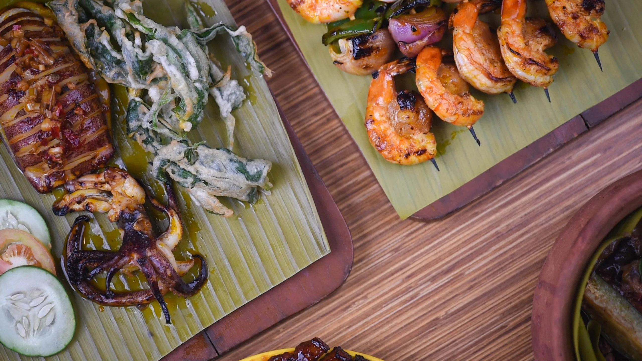 Family meal shared on banana leaves at a long table