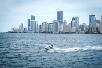 a person on a jet ski in front of a city skyline