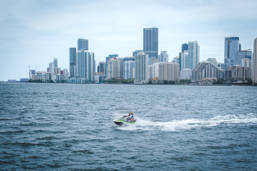 a person on a jet ski in front of a city skyline