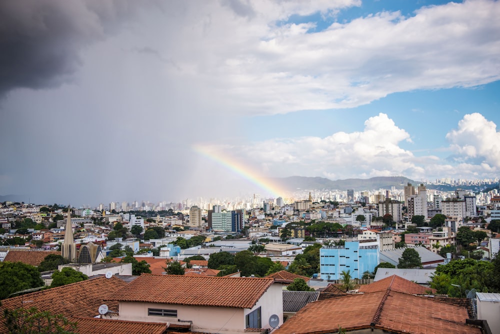 a rainbow in the sky over a city