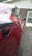 Photo of a shiny, freshly detailed red sedan parked in a driveway.