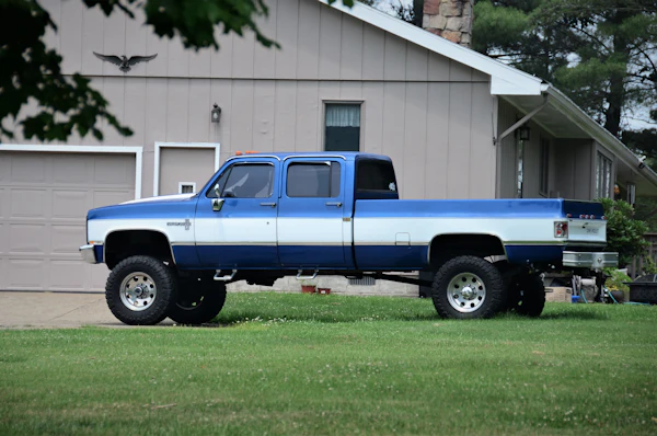 Blue and white pickup truck parked outside