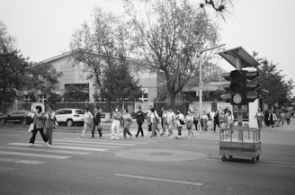 Kids practicing crossing the street safely on a mock pedestrian crossing set up in the schoolyard.