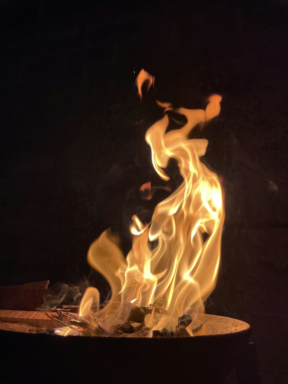a fire burning in the dark with a black background