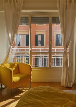 Bright living room freshly cleaned with sunlight streaming through blue curtains.