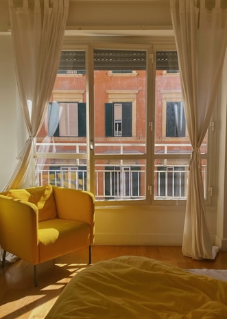 Restoration equipment drying out a flooded living room with sunlight streaming through windows.