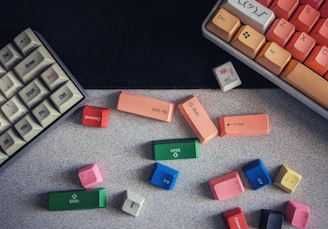 A vibrant collection of colorful keyboards and mice arranged neatly on a display shelf.