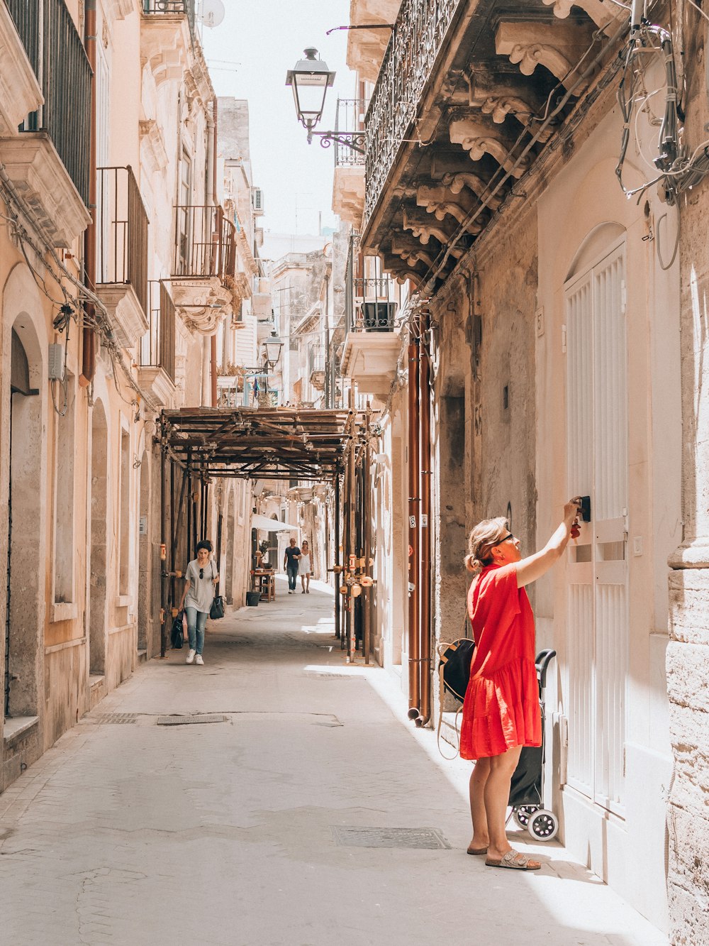 a woman in a red dress is taking a picture