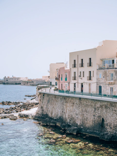 a row of buildings next to a body of water