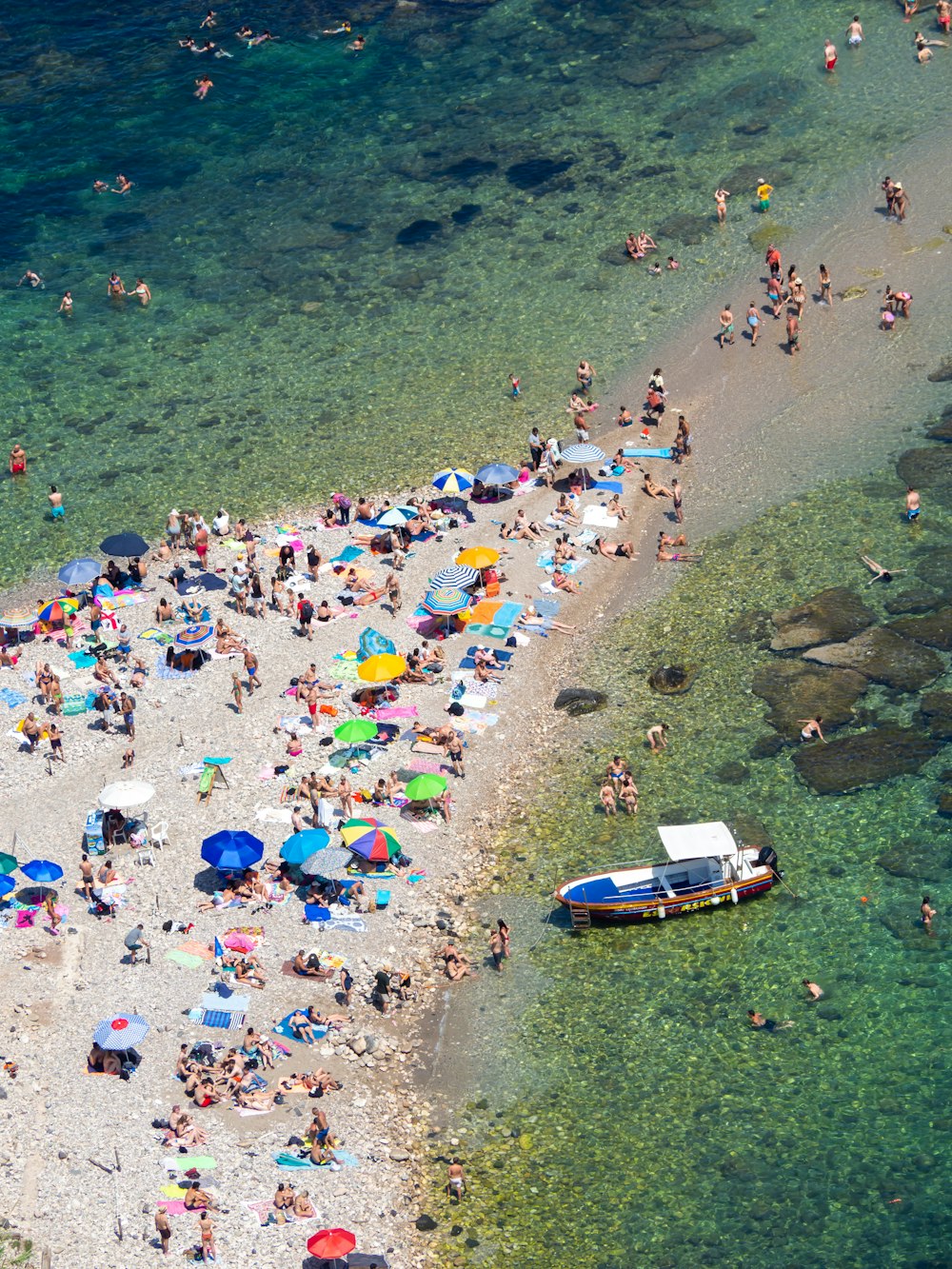 a group of people standing on top of a sandy beach