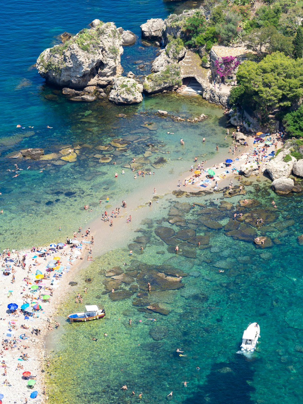 a group of people on a beach next to a body of water