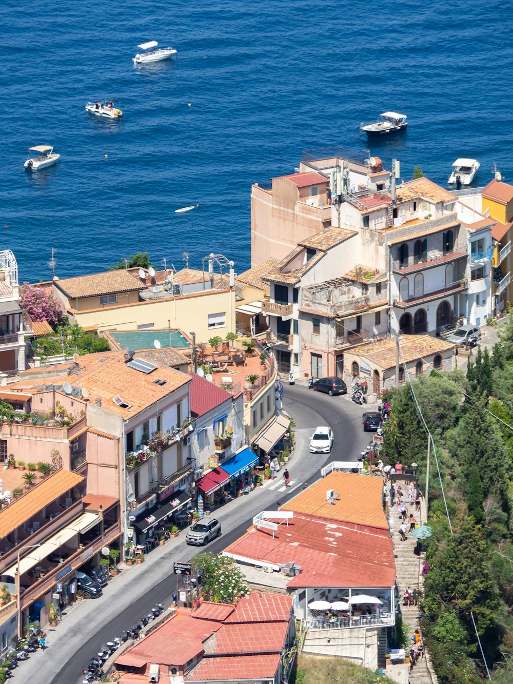 an aerial view of a city with boats in the water