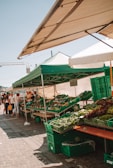 A bustling farmers market stand filled with fresh fruits and vegetables.