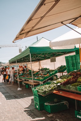 A bustling farmers market stand filled with fresh fruits and vegetables.
