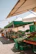 Close-up of a vibrant, fresh farm market stand with colorful vegetables and happy customers.