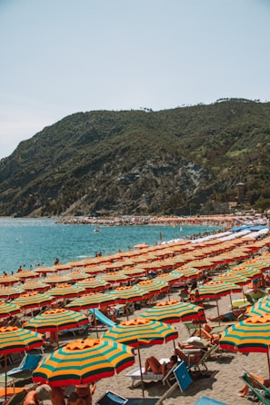 A group of colorful beach umbrellas shading a lively seaside picnic