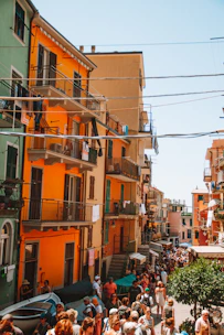 A vibrant street scene in Santa Catarina with locals engaging and colorful buildings under a bright sky.