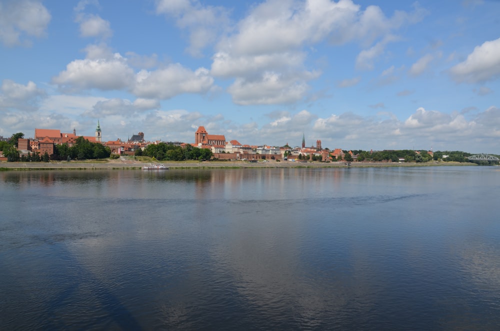 a body of water with a city in the background