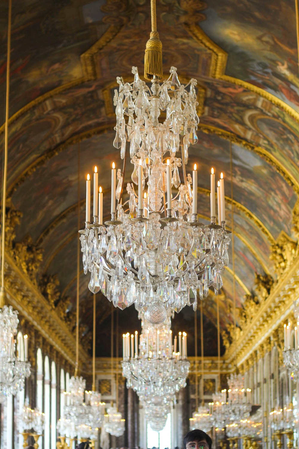 a chandelier hanging from a ceiling in a palace