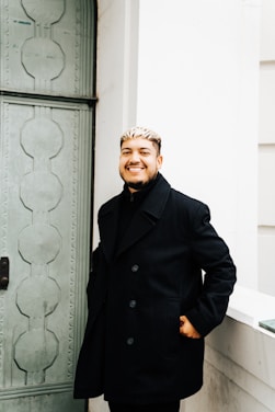 a man standing in front of a green door
