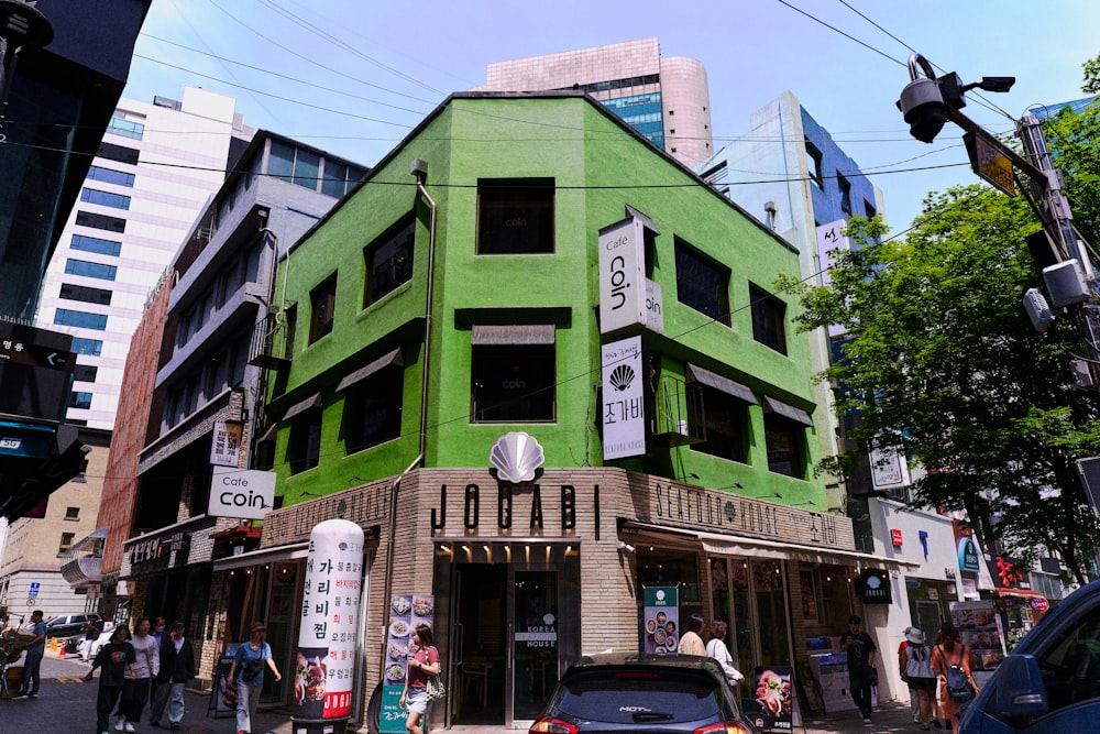 a green building on a city street corner