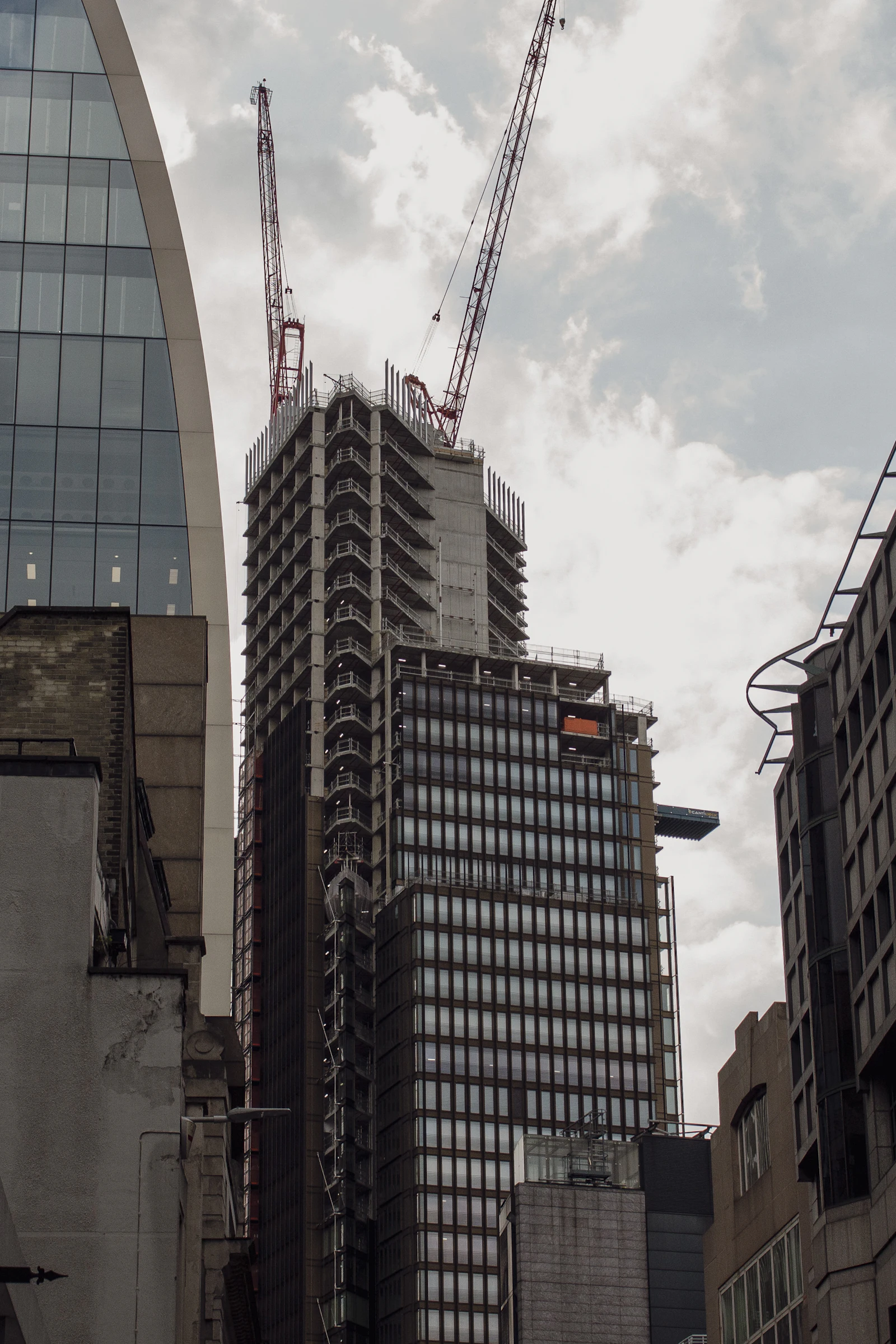 A tall building under construction with a crane on top