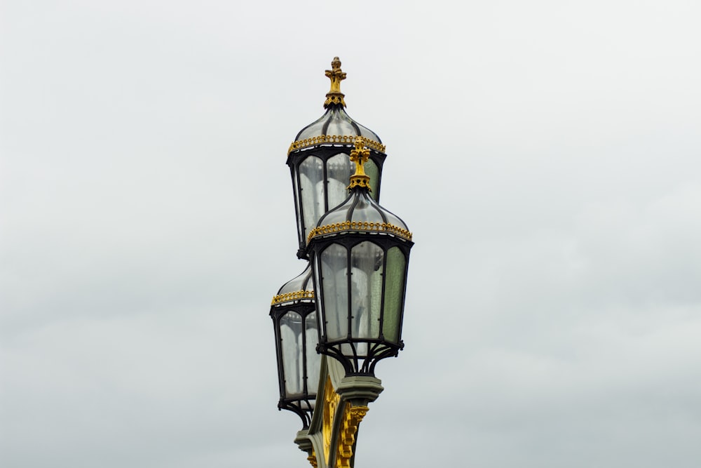 a tall light pole with a clock on top of it