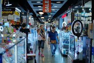 a couple of people that are walking down a store