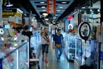 a couple of people that are walking down a store