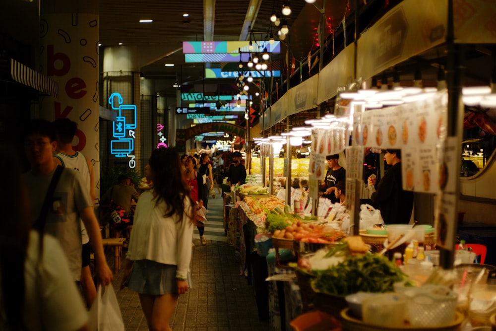 a group of people walking around a market