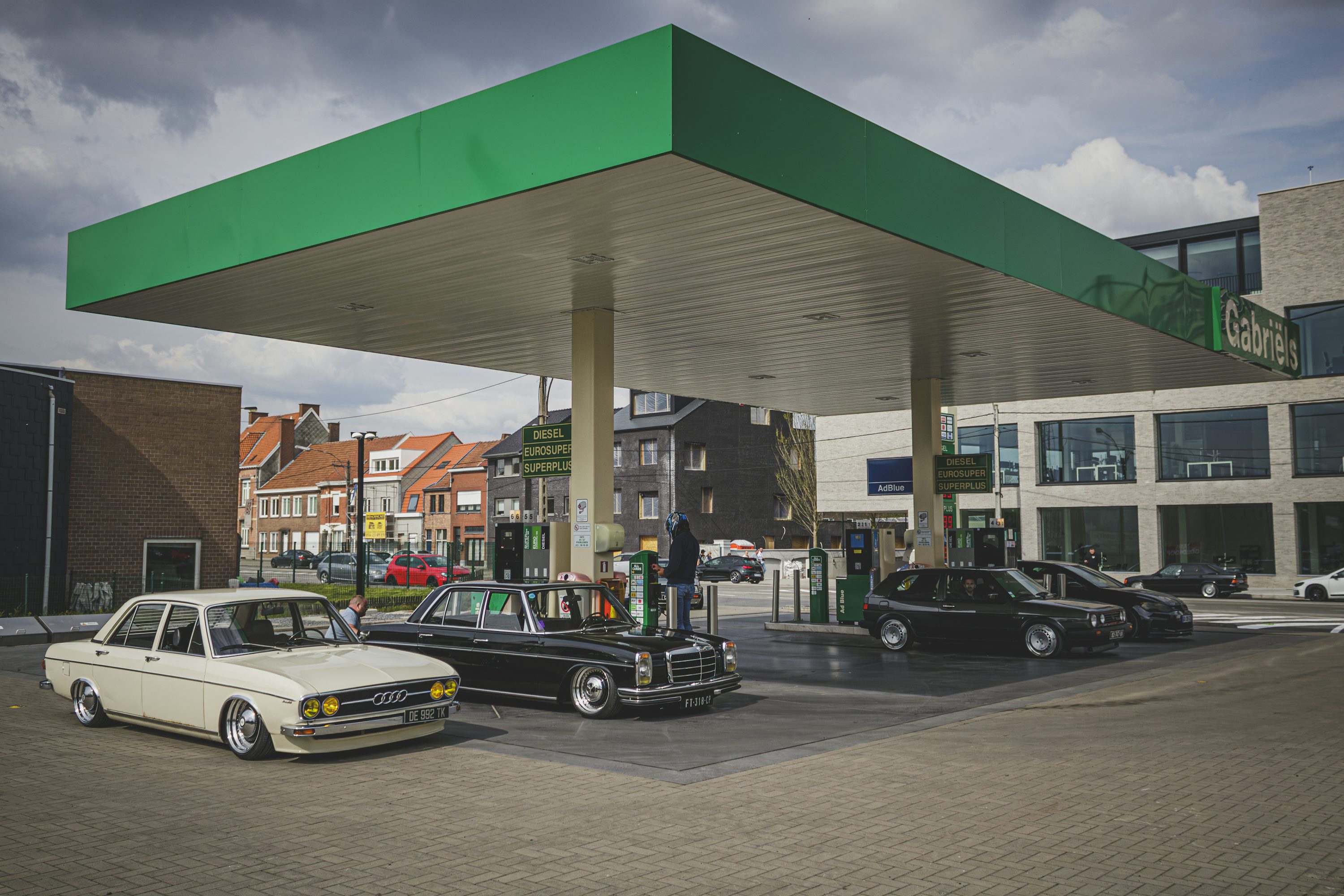 a gas station with cars parked in front of it