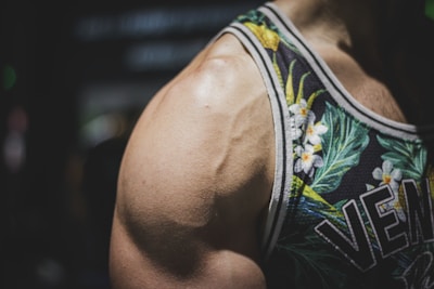 Close-up of a high-quality gym tank top with custom embroidery and vibrant colors.