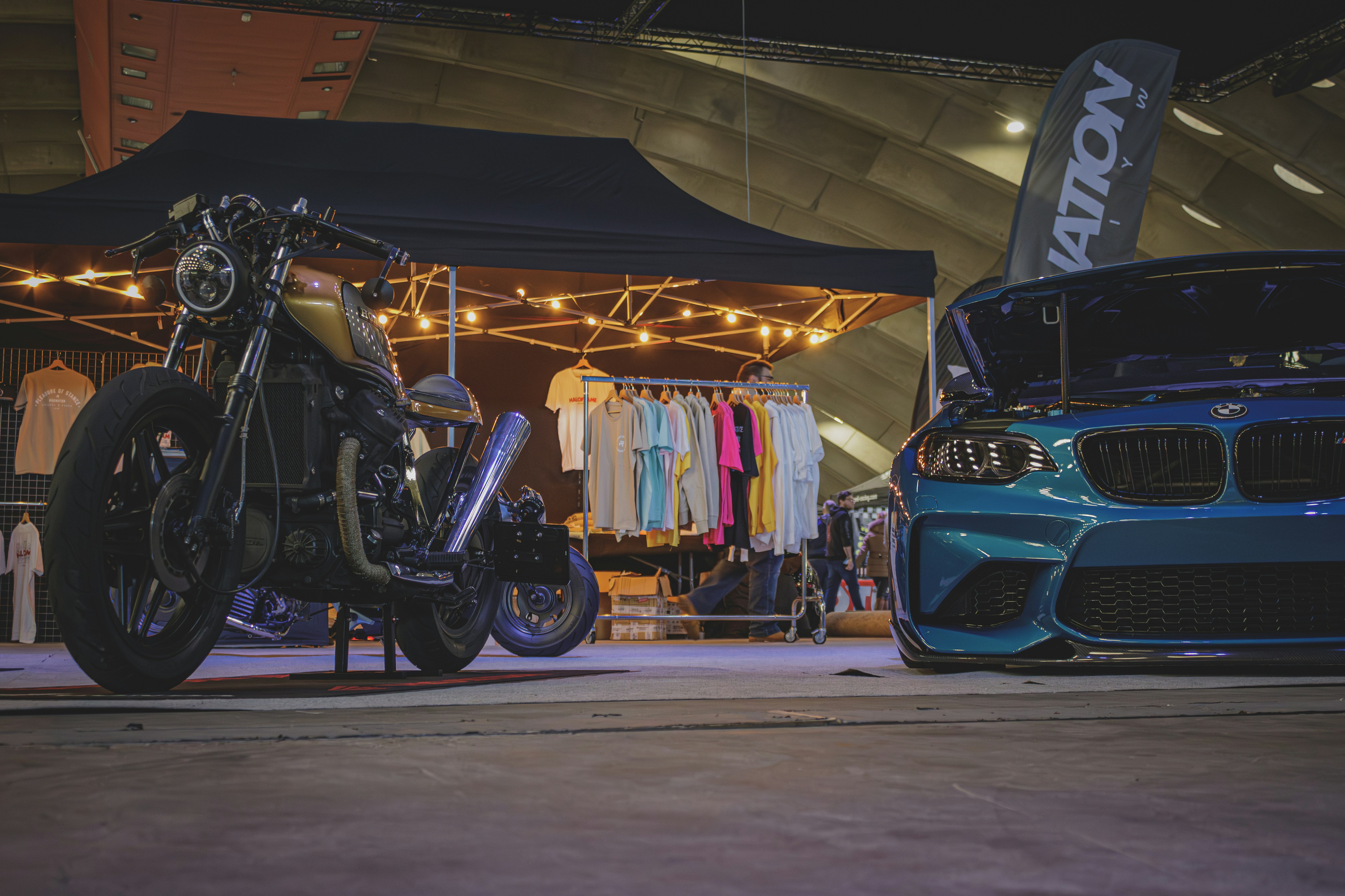 a blue motorcycle parked next to a blue car