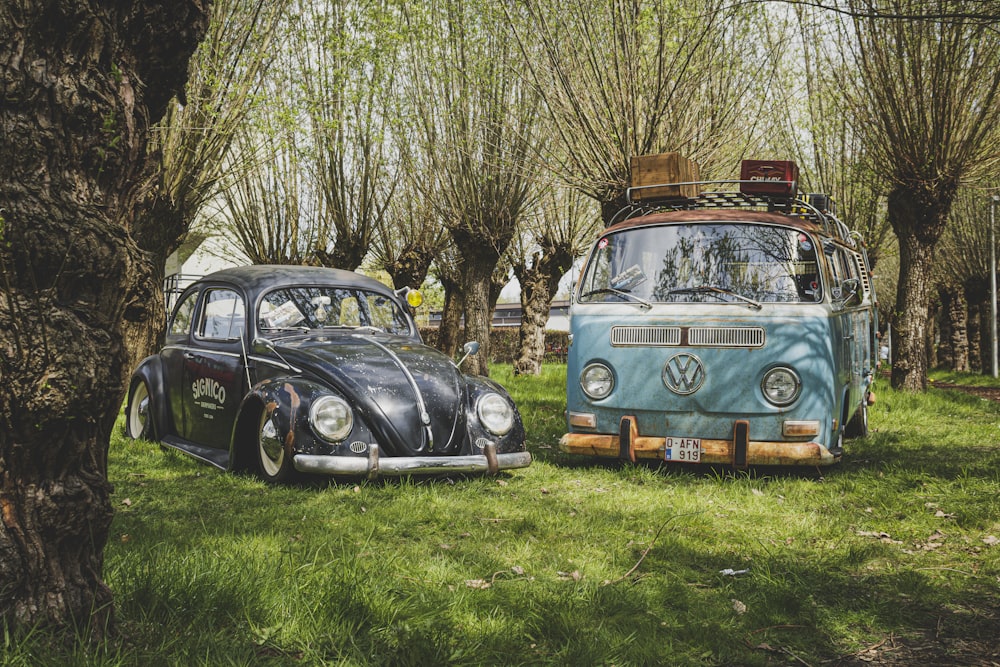 a couple of cars parked next to each other in a field