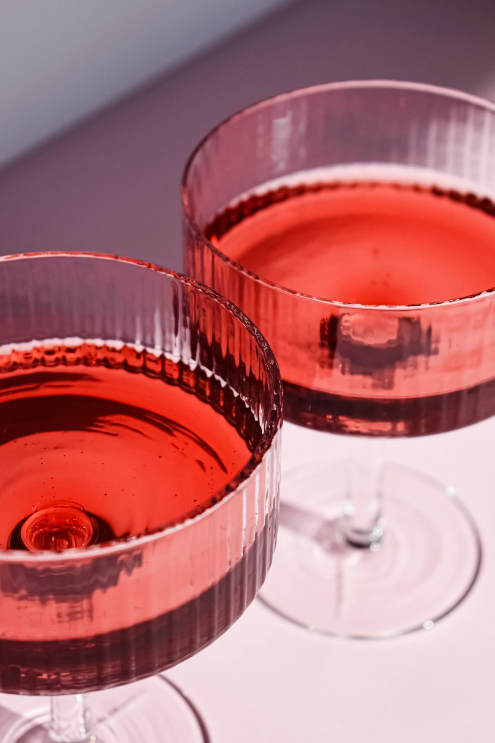 a close up of two glasses of wine