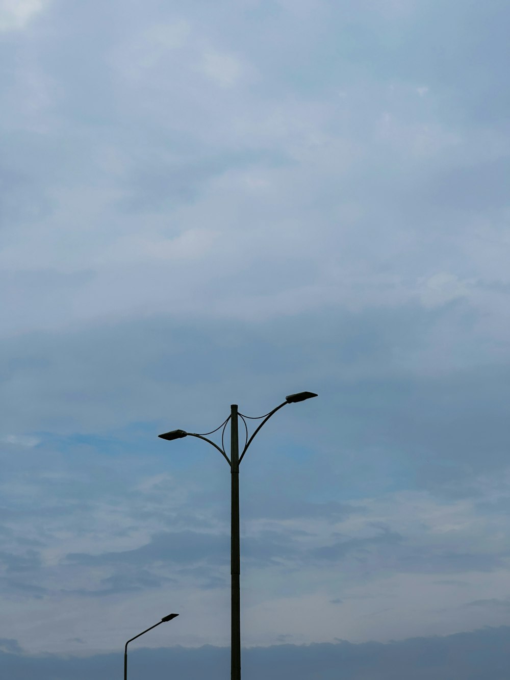 a couple of street lights sitting on the side of a road